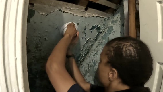 Firefighters install smoke alarms inside Strawberry Mansion homes after deadly fire