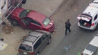 Philly officer hit during traffic stop before car crashes into home, officer uninjured