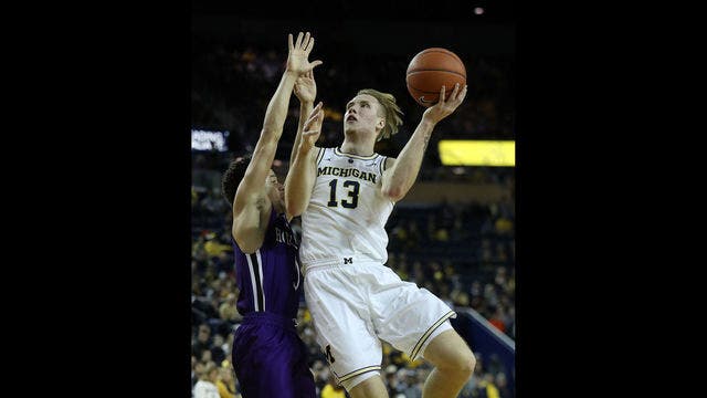 Brazdeikis leads No. 19 Michigan over Holy Cross 56-37