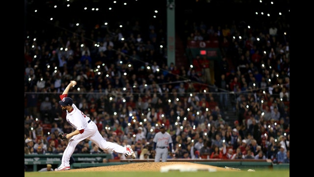 Fans using cell phones cause brief delay at Fenway