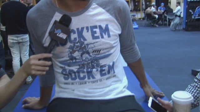 Tate sports Rock 'Em Sock 'Em t-shirt that you can buy