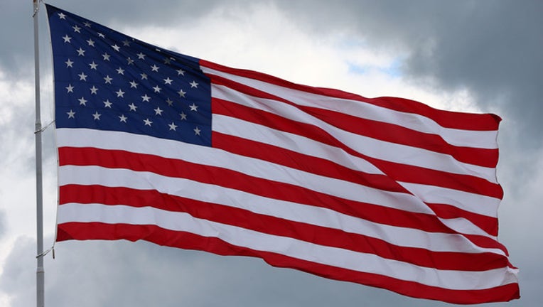 flag waving getty image 159332346CC00529_Aaron_s_49_1518796115397