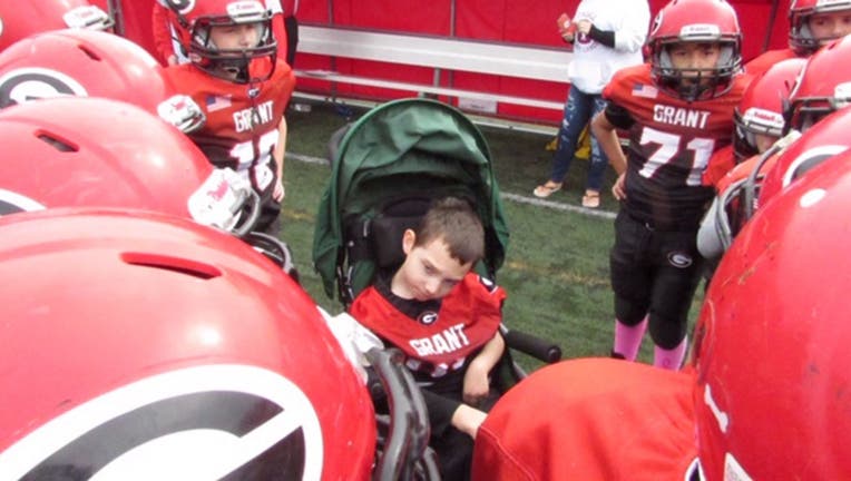 The Grant Jr. Bulldogs youth football team in Fox Lake, Ill., made Bryson Jenkins, who has cerebral palsy, the honorary captain on October 5 and now he is officially considered part of the team, Brittany Jenkins, Bryson’s mother, said. (Brittany Jenkins)