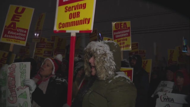 Utica teachers rally in struggle against school district over pay