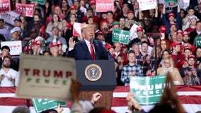 Trump blasts impeachment effort at Michigan rally as Congress votes to impeach