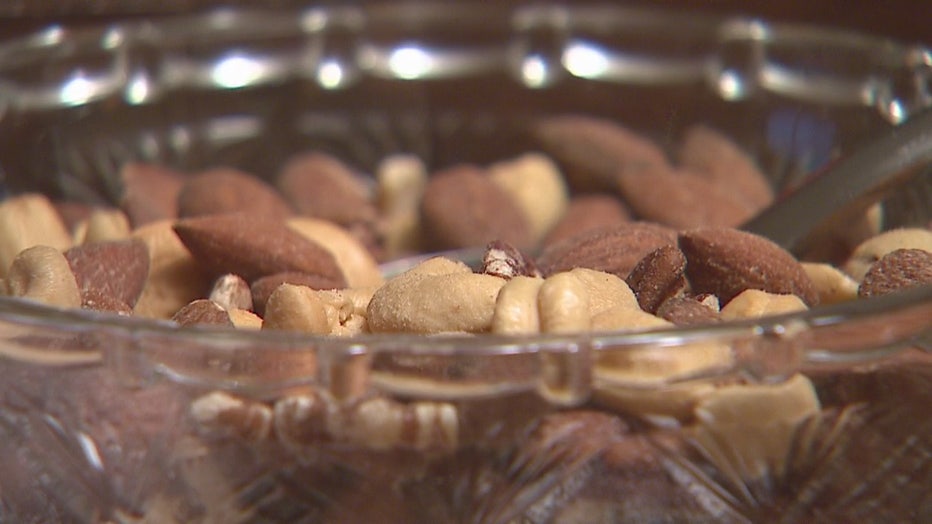 An array of mixed nuts in a clear glass bowl.