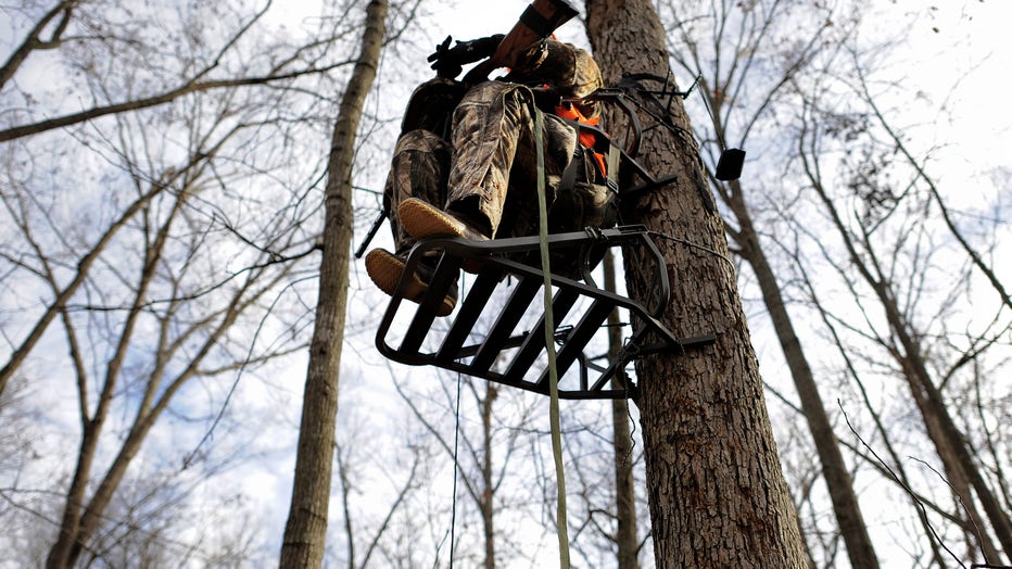 Michigan deer hunter sprays deer repellent on brother's deer stand