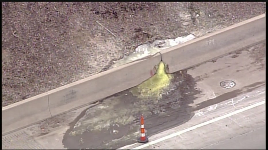 A photo of fluorescent green chemicals coming out of a crack in the side of the wall on I-696..