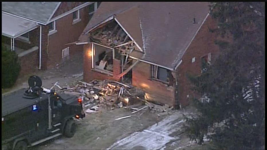 An aerial photo of the suspect's house, where a hole has been punched in the top floor.