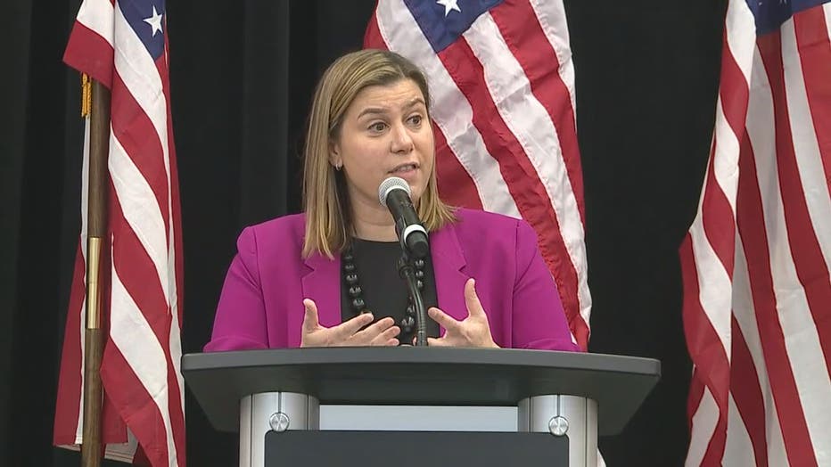 A photo of Rep. Elissa Slotkin speaking at a podium surrounded by American flags.