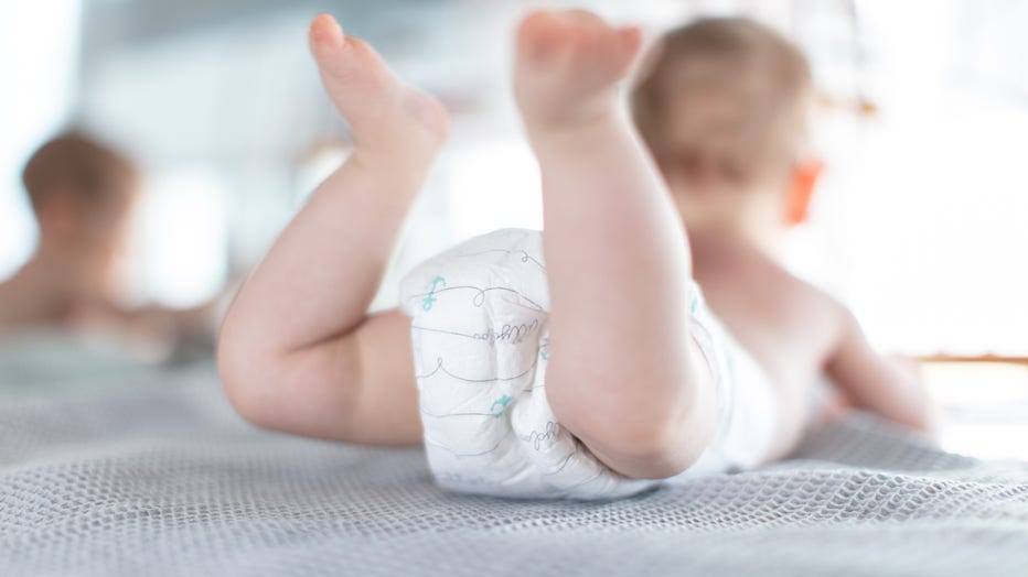 25 February 2019, North Rhine-Westphalia, Bielefeld: An infant wears Pampers while lying on a chest of drawers. Photo: Friso Gentsch/dpa (Photo by Friso Gentsch/picture alliance via Getty Images)