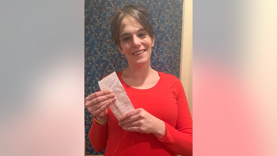 A photo of Danielle Franzoni smiling, holding her tip receipt