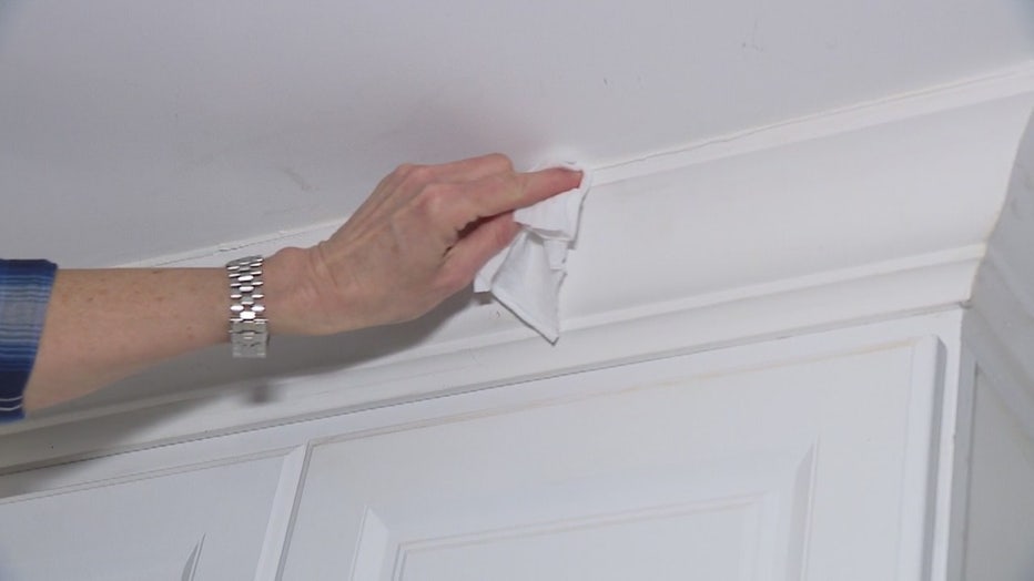 Jill wipes up excess caulk
