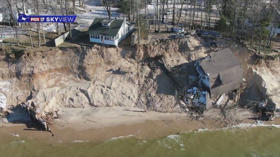 Drone footage shows a cottage collapsed at the bottom of a beachside cliff