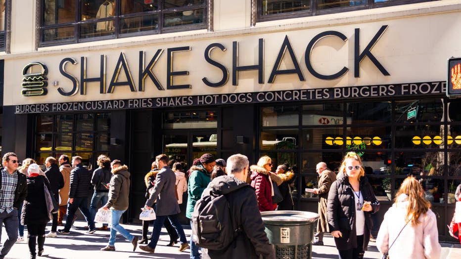 Pedestrians walk past an American fast casual restaurant