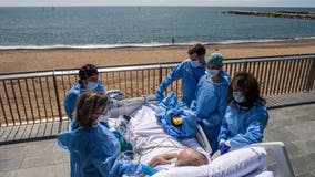 Hospital staff in Spain wheels recovering coronavirus patients to the beach