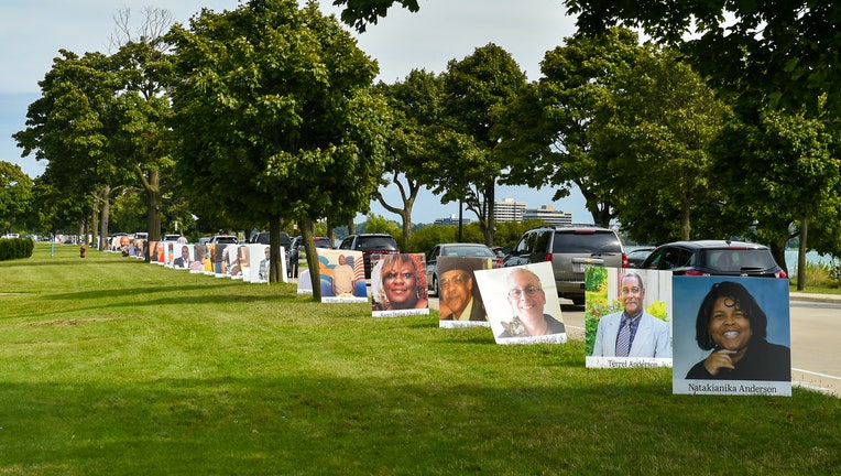 Images of COVID-19 victims from Detroit are displayed in a drive-by memorial at Belle Isle State Park in Detroit, Michigan.