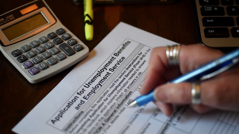 In this photo illustration, a person files an application for unemployment benefits on April 16, 2020, in Arlington, Virginia.