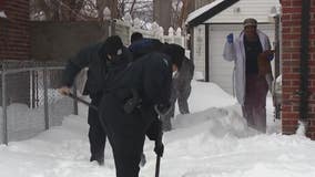 Detroit police officers shovel snow for elderly residents after winter storm