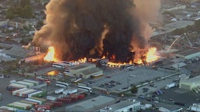 Massive fire burns in industrial area of Compton