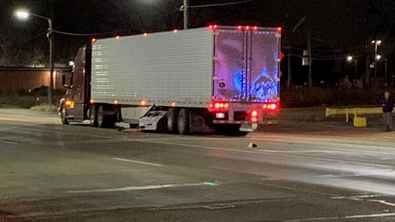 Detroit man charged after crashing Tesla under semi-truck, critically injuring woman