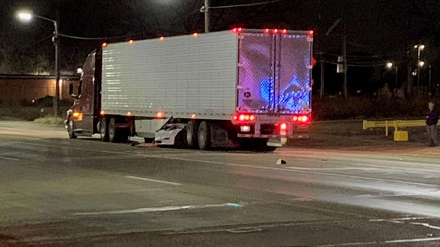 Detroit man charged after crashing Tesla under semi-truck, critically injuring woman