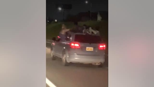 VIDEO: 2 ride on roof of SUV on I-96 in Detroit while others hang out of windows