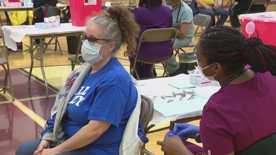 A woman receives the COVID-19 vaccine at a Detroit location.