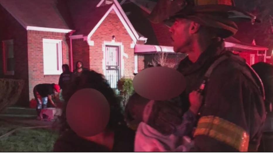 Detroit Firefighter Lavaughn Williams with the baby he rescued inside the burning home.