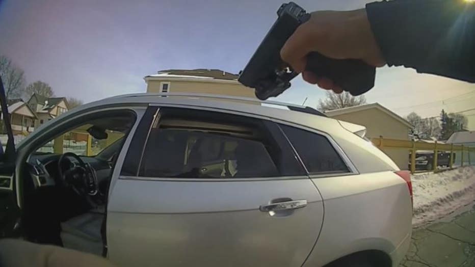 Video still taken from River Rouge police stop of Maliyah Clary. An officer draws a gun pointed at her 14- and 15-year-old cousins of Clary inside the car.