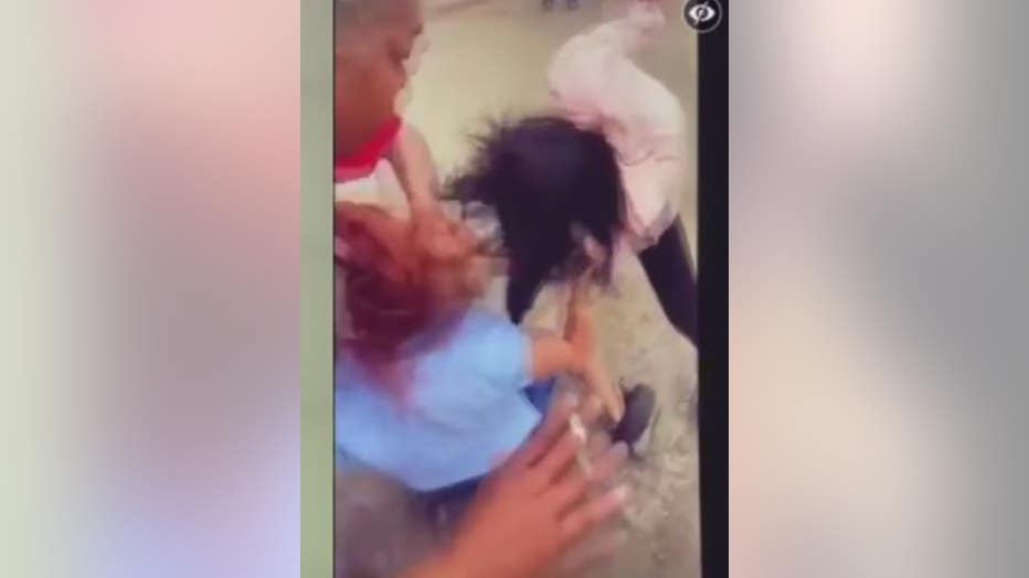 Video still of the fight between two women and a US postal carrier.
