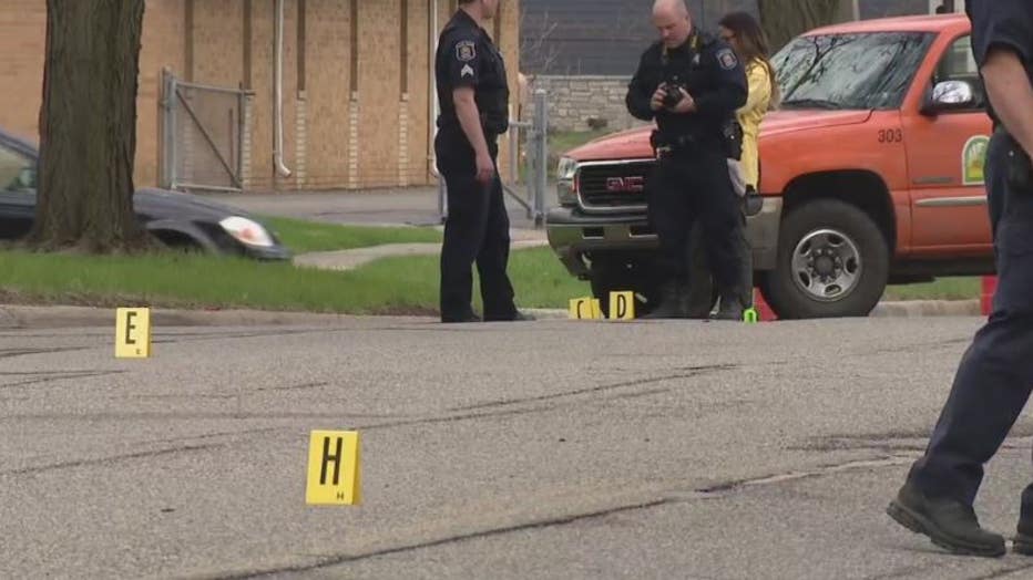 Police gather near the evidence markers Monday.