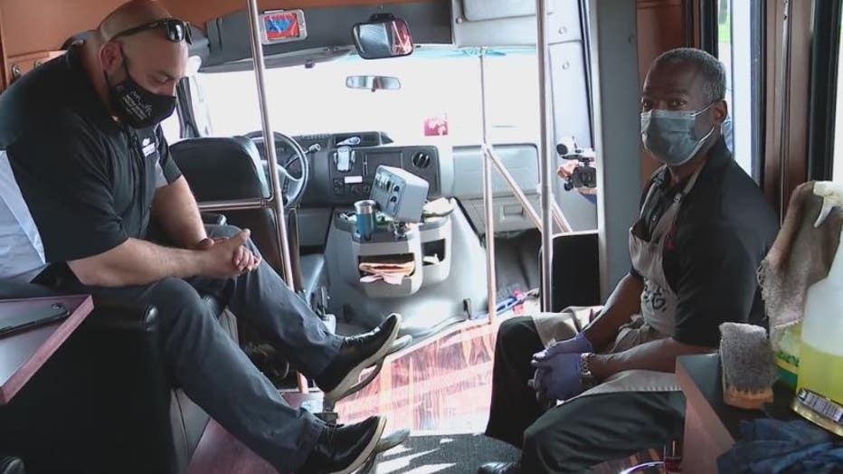 Mr. E and a customer inside the mobile shoeshine shuttle.