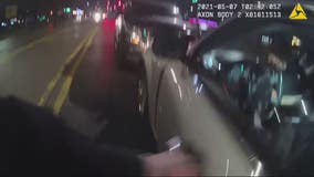 Police bodycam video shows rescue of overdosing driver inside running car