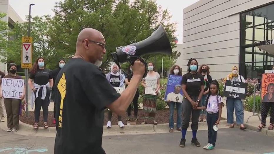 Activist Edwards Barakah Sanders leads a chant at the protest outside the Dearborn administrative building.