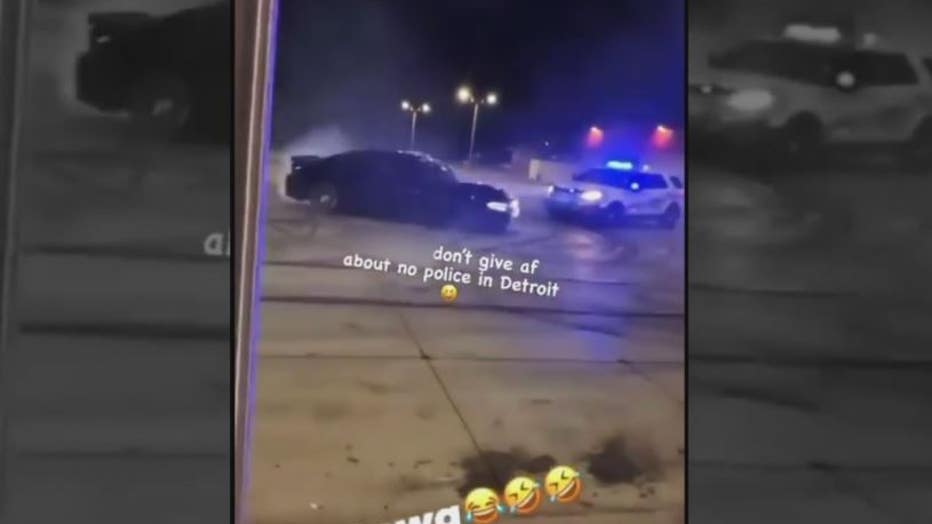 Still shot of a viral video of a Dodge Charger doing donuts around a Detroit police cruiser.