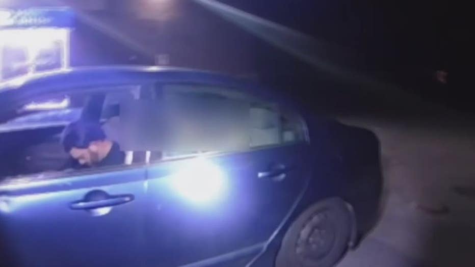 Emory Lewis sleeping inside his car on police bodycam.