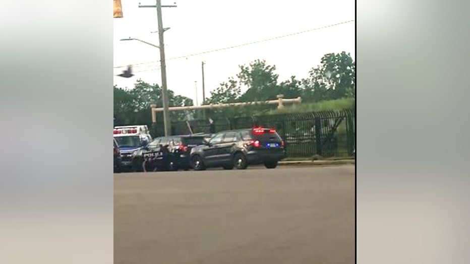 An officer can be seen on the ground in front of the stolen ambulance.