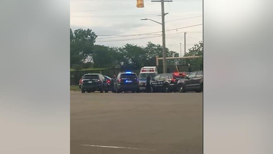 An officer can be seen on the ground in front of the stolen ambulance.