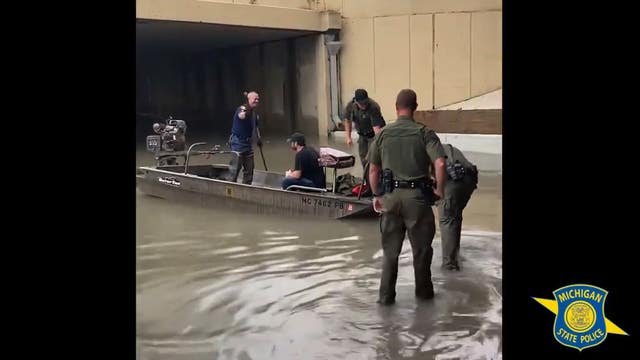 WATCH: Man rescued from roof of car after getting stranded on flooded Detroit freeway