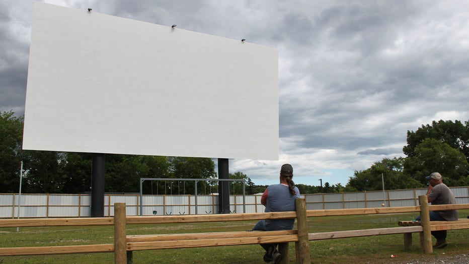 Don Collins (left) and Todd Williams (right) in front of their Drive-in movie theater screen