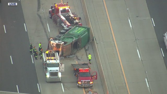 Overturned garbage truck blocking multiple lanes on I-75