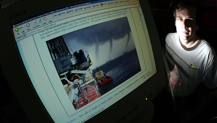 David Mikkelson next to his computer monitor with a doctored storm photo in which two extra tornados
