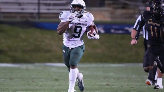 Walker runs for 264 yards as Spartans beat Wildcats 38-21