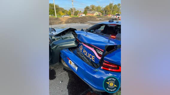 Driver slams into Michigan State Police patrol car while trooper works to remove abandoned vehicle from road