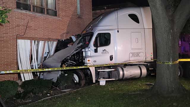 Semi-truck driver flees crash after striking five parked cars, running into Detroit apartment