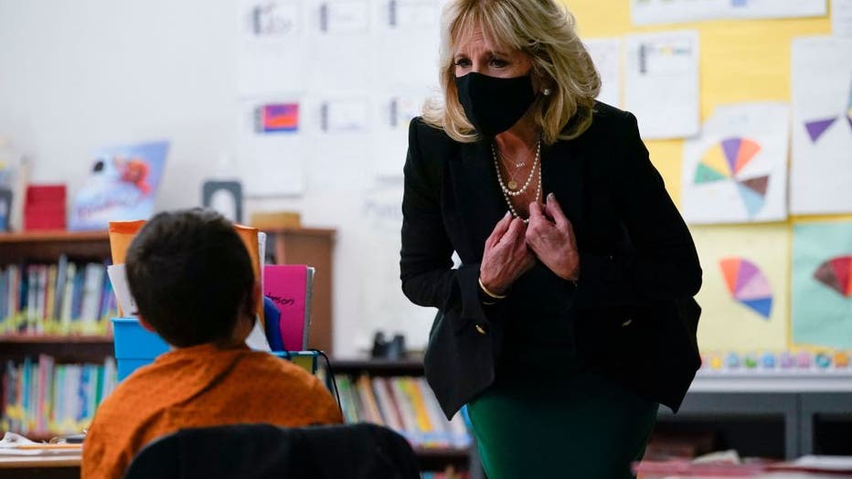FILE - First lady Jill Biden speaks with a student as she visits the Christa McAuliffe School in Concord, New Hampshire, on March 17, 2021. ( (Photo by SUSAN WALSH/POOL/AFP via Getty Images)