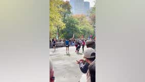 2 runners stop to help fellow runner over NYC Marathon finish line