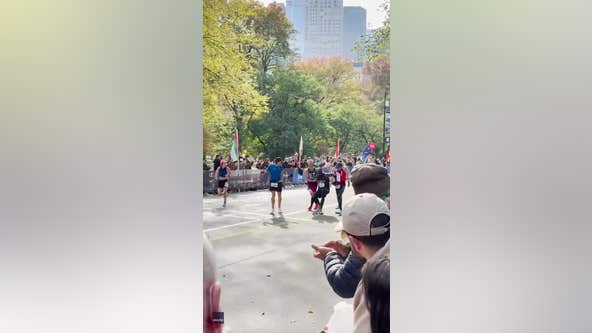 2 runners stop to help fellow runner over NYC Marathon finish line
