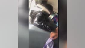 Video shows woman restrain small child, sit on him in school bus struggle